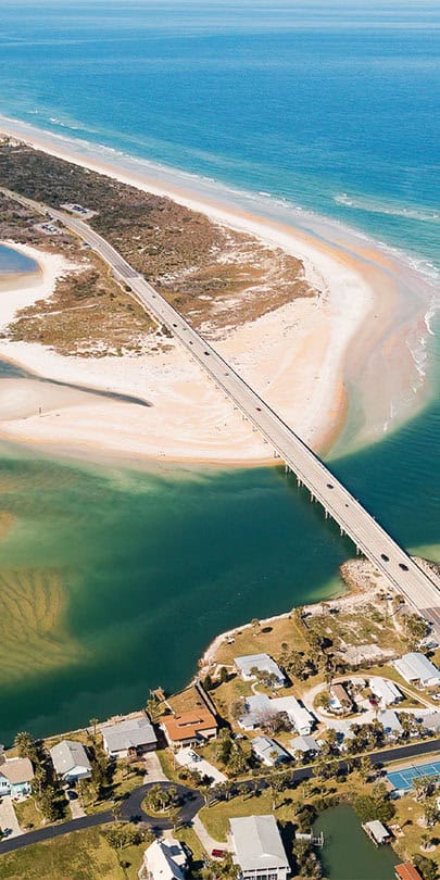 Ocean inlet with a bridge and beach, ideal for dog training in Vilano Beach, FL.