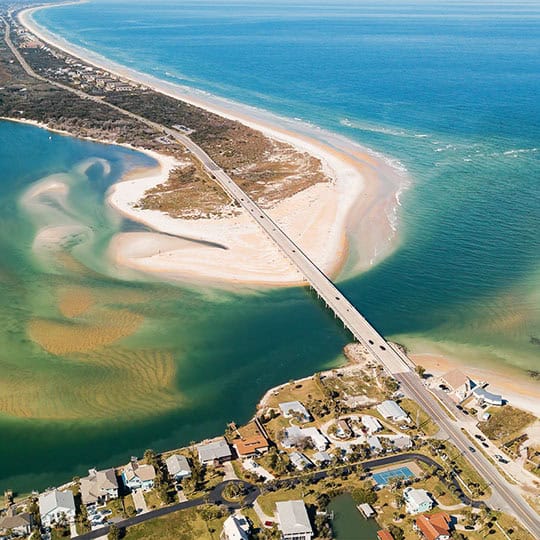 Ocean inlet with a bridge and beach, ideal for dog training in Vilano Beach, FL.
